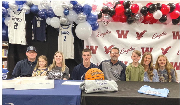 ► Nate Reherman signs with SWOSU at Weatherford High School. He’s pictured with his family.